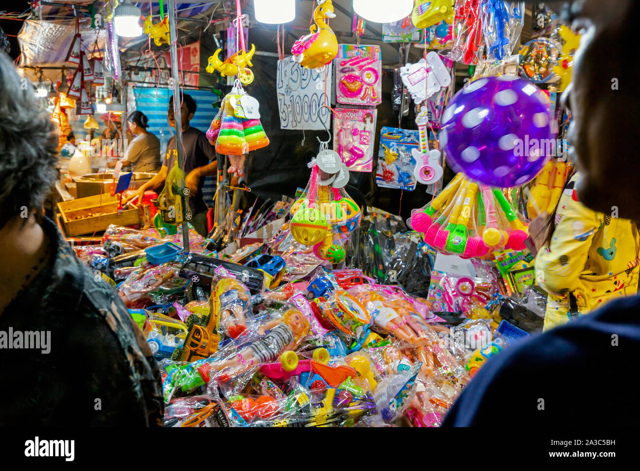 Asiatische Menschen sind auf der Suche nach Kunststoff Spielzeug in China auf einer Messe und Karneval in Kampong Cham, Kambodscha, Stockfoto