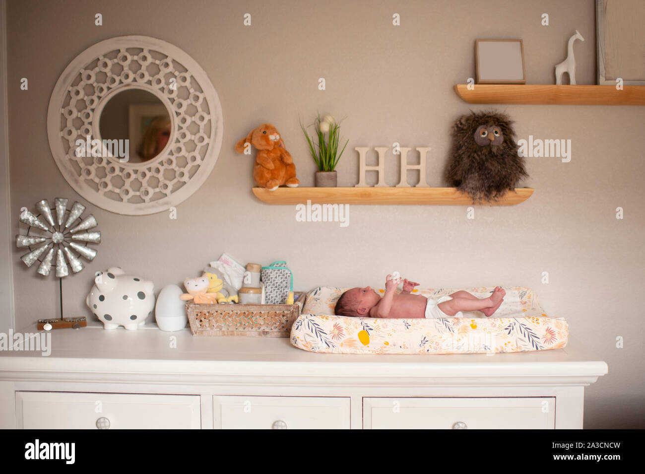 Neugeborene Mädchen mit auf Wickeltisch in der Windel zu Hause Stockfoto