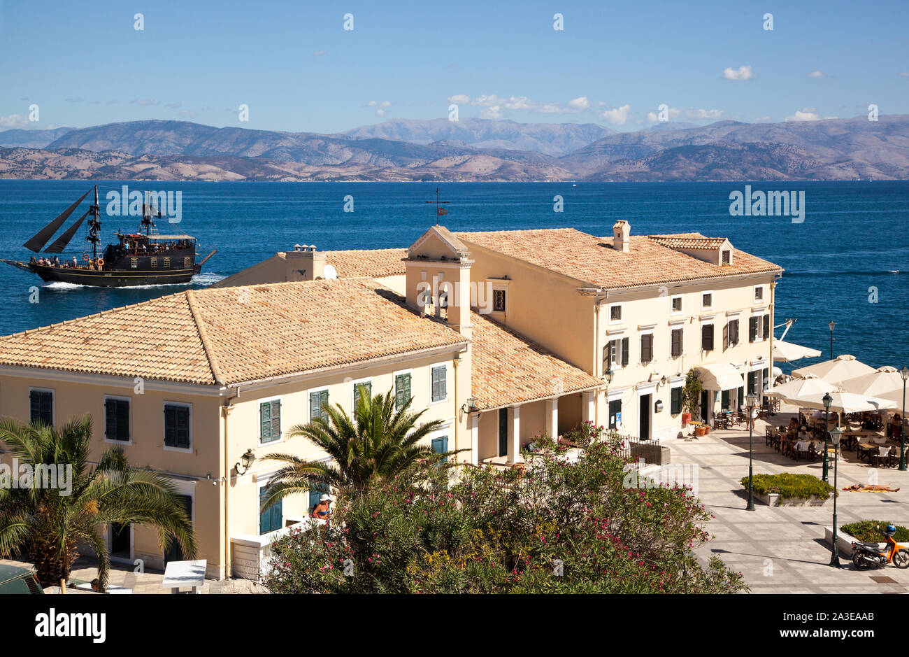 Blick auf eine Taverne und Restaurant am Hafen Hafen von Korfu - Stadt auf der griechischen Insel Korfu Griechenland und Albanien in der Ferne Stockfoto