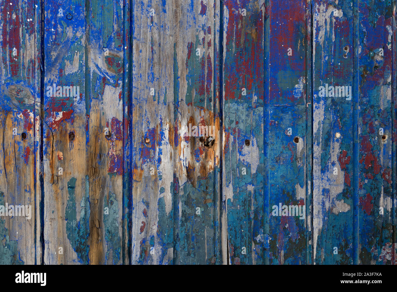 Alte hölzerne grungy texturierte Zaun mit gebrochenen Farben full frame Stockfoto