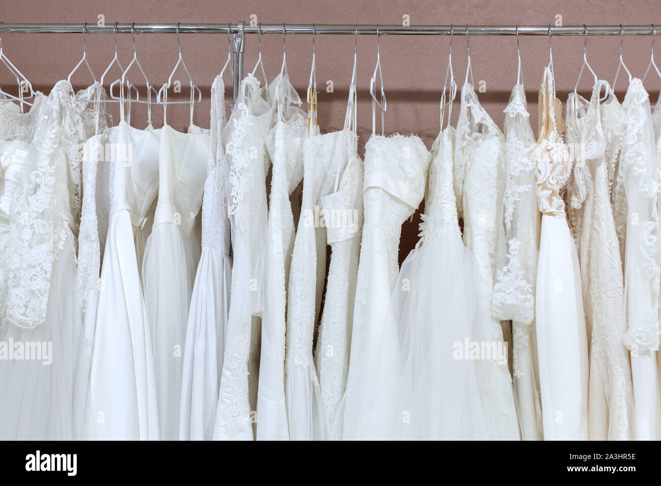 Auf der Zähler im Bridal Salon sind viele schöne weiße Brautkleider. Stockfoto