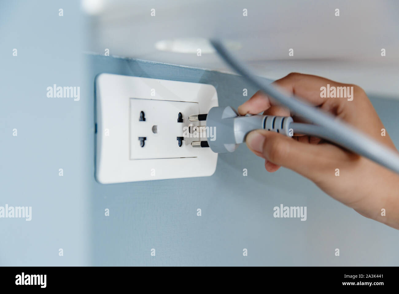 Steckdose mit eingestecktem Stecker an hellblauer Wand, Platz für Text.  Stromversorgung Stockfotografie - Alamy