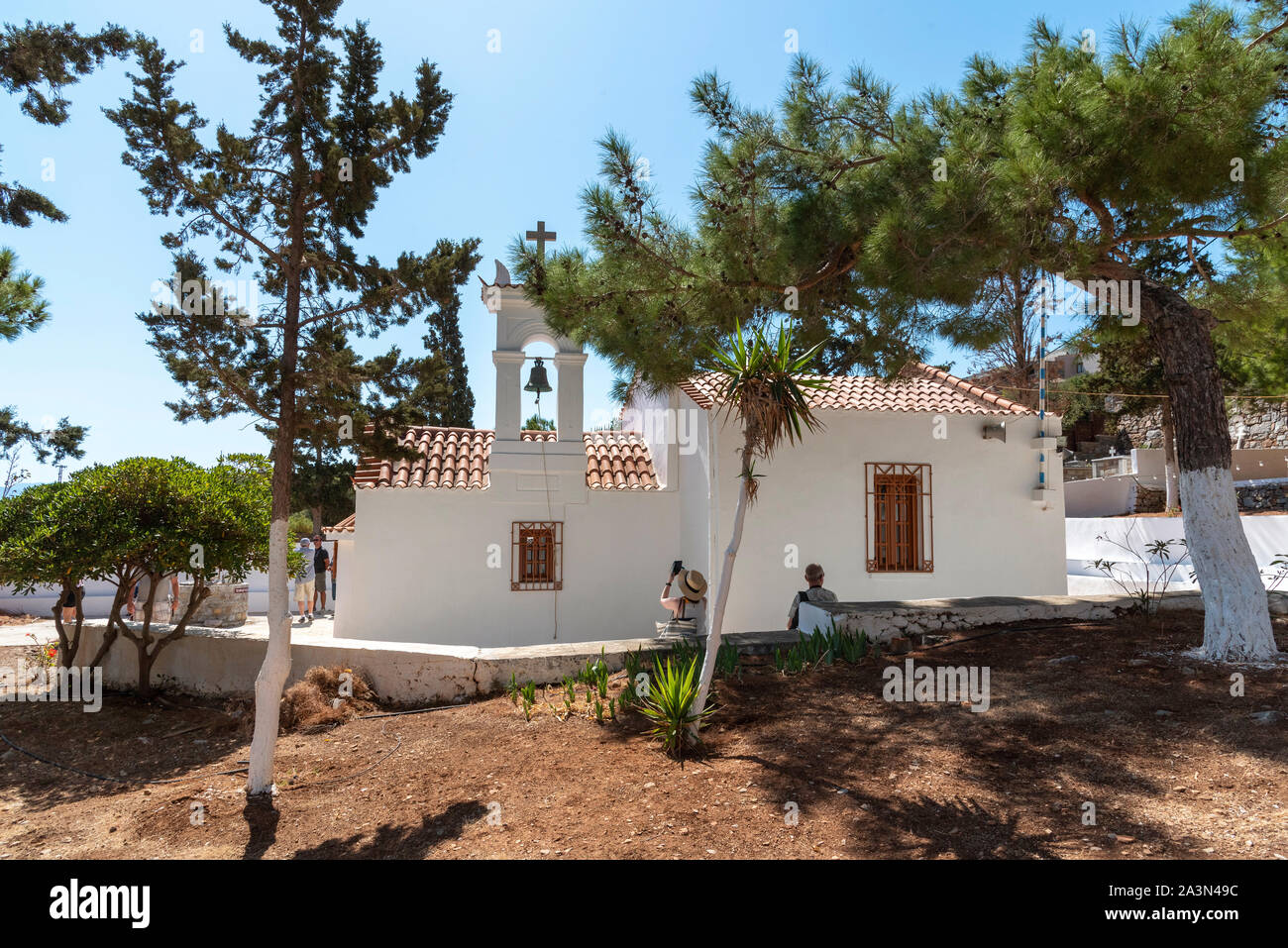 Plaka, Kreta, Griechenland. Oktober 2019. Die Saint Marina Kirche in Plaka, Kreta, Besucher draußen sitzen. Stockfoto