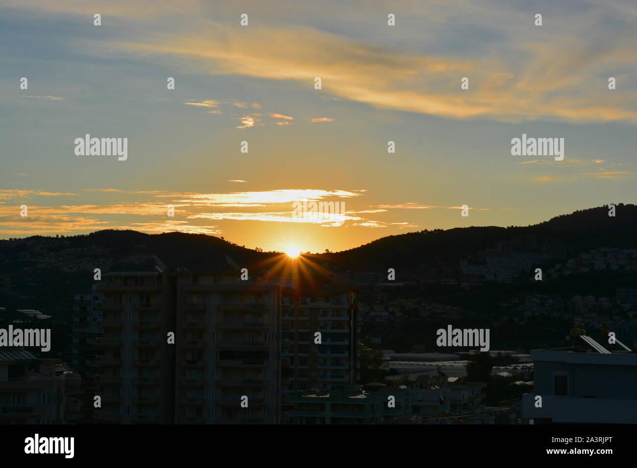 SUNRISE Mahmutlar, Alanya Türkei. Die Sonne über dem Kargicak Hügel und mahmutlar Dächer und Leuchtet der Himmel als der neue Tag beginnt. Stockfoto