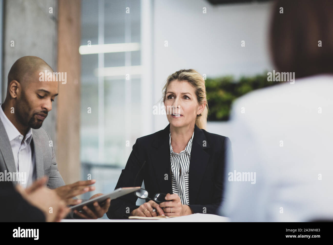 Ältere weibliche Führungskraft an der Spitze eines Corporate Meeting Stockfoto