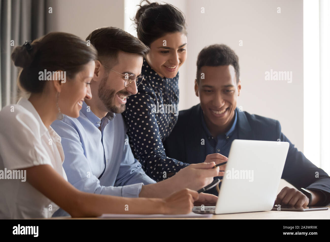 Lächelnd diverse ethnische Gruppe der Arbeitnehmer erfassen auf Laptop zeigen Stockfoto
