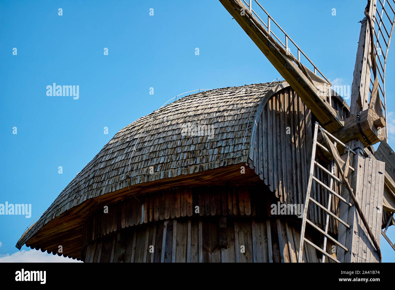 In der Nähe einer alten Windmühle aus Holz unter freiem Himmel stehen Stockfoto
