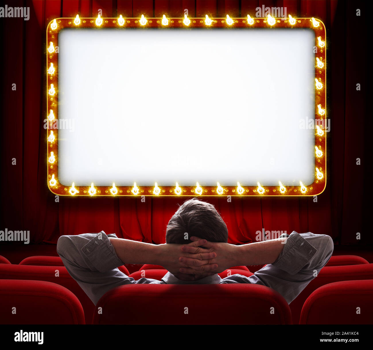 Mann vor der beleuchteten Zeichen auf roten Theatervorhang Hintergrund sitzen Stockfoto