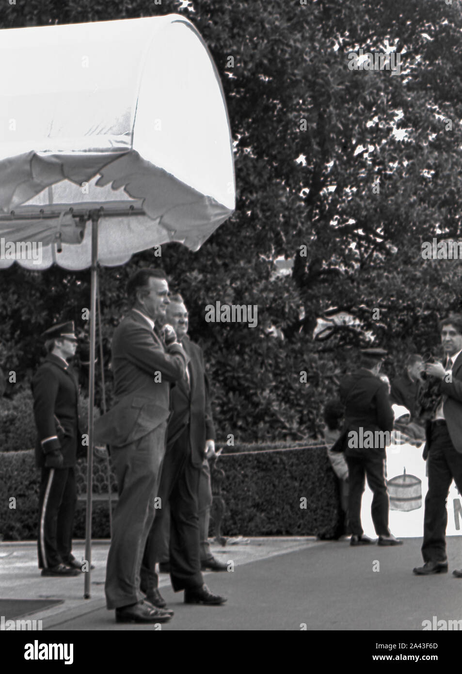 Washington DC. USA, 5. Februar 1984 Vice President George H.W. Bush und Attorney General benennen, Edwin Meese stand auf der südlichen Vorhalle Vordach wartet Präsident Ronald Reagan und First Lady Nancy Reagan nach ihrer Rückkehr aus Camp David zu begrüßen Stockfoto