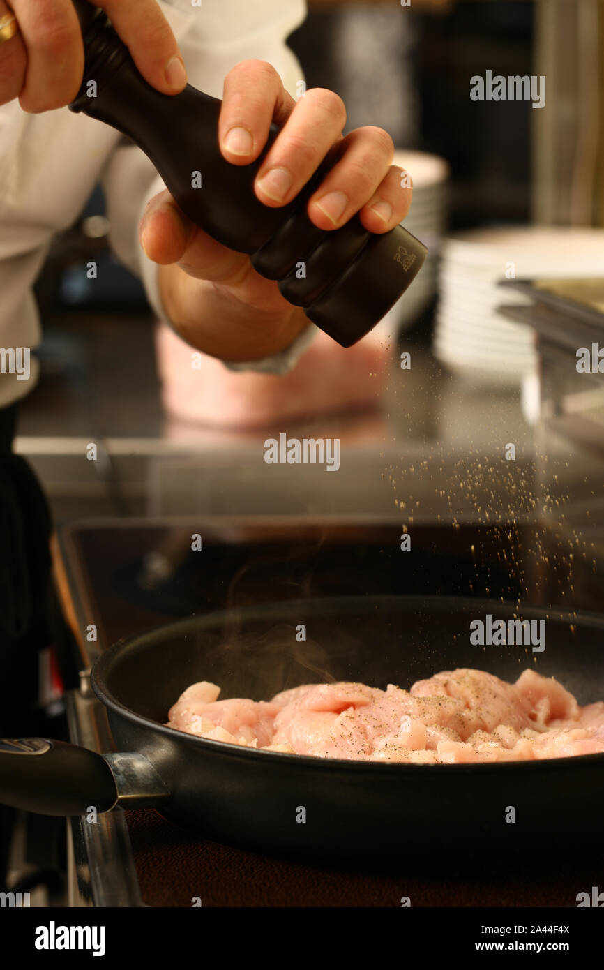 Koch in der Küche die Zubereitung von Speisen für Kunden mit Händen und Dienstprogramme Stockfoto