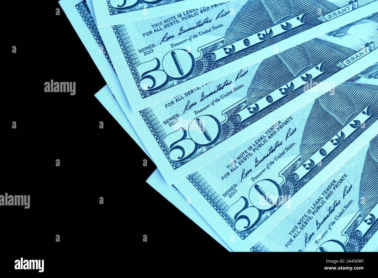 Fünfzig Dollar Banknoten auf schwarzem Hintergrund schließen isoliert. Farbe blau Toning Stockfoto