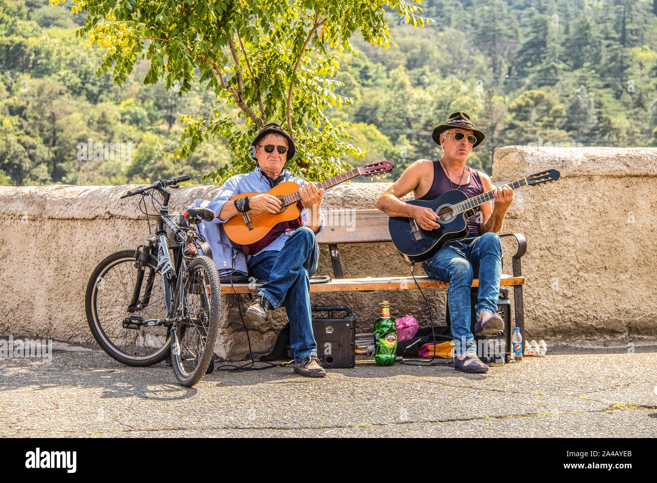 7-15 2019 Tbilisi Georgien - zwei Musiker auf der Bank sitzen an touristische Ort in der Nähe von Burg oberhalb der Stadt spielen Gitarren mit Bier zwischen Ihnen und einem Pat Stockfoto