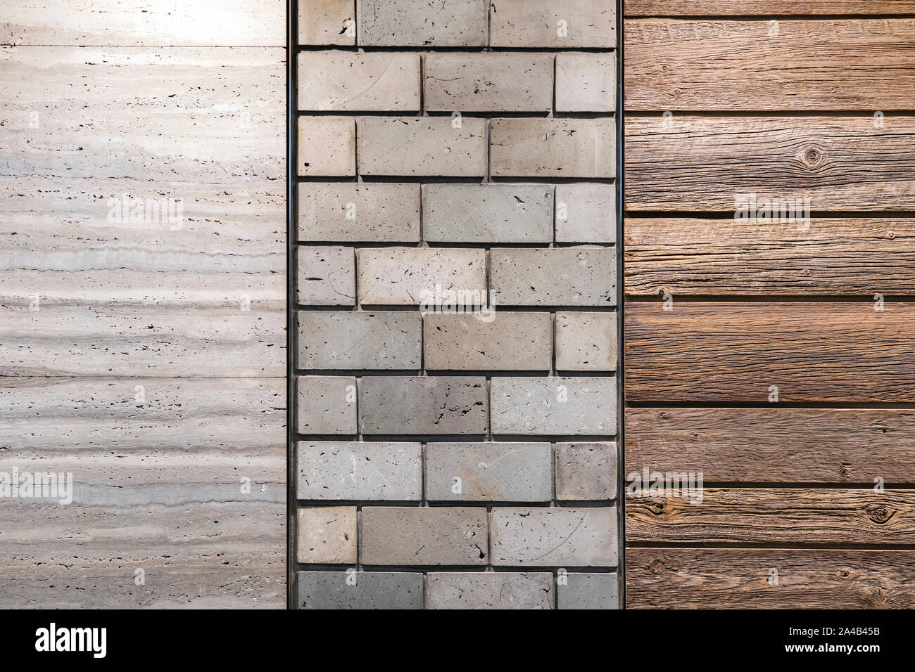 Die texturierte Wand durch Beton Ziegel, Holz Bretter und Naturstein graue Farbe an. Stockfoto