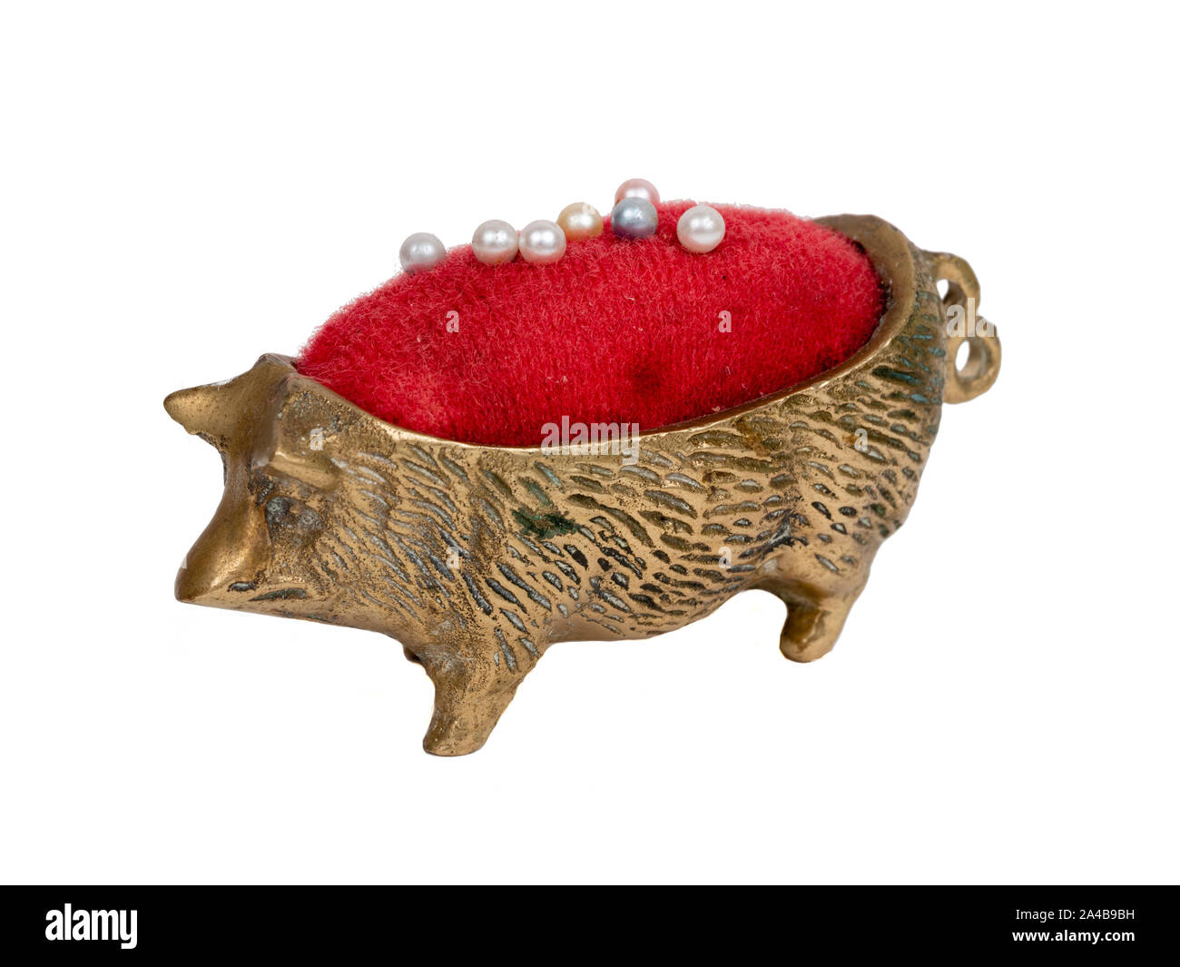 Kleine messing Nadelkissen in der Form eines Schweins mit roten velver Einfügen auf weißem Hintergrund Stockfoto