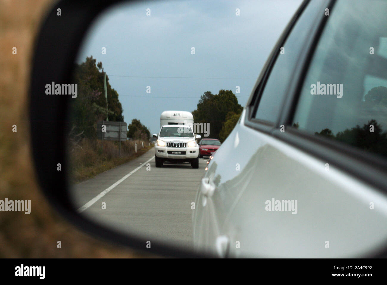 Treiber anzeigen Verkehr hinter der hinteren Vision Spiegel, Pacific Highway in der Nähe der Grafton, NSW, Australien. Stockfoto