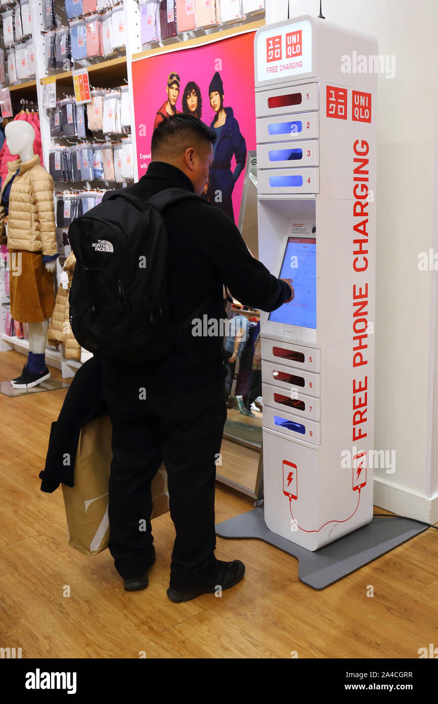 Eine Person verwendet ein ChargeItSpot Telefon laden Kiosk in einem Store entfernt Stockfoto