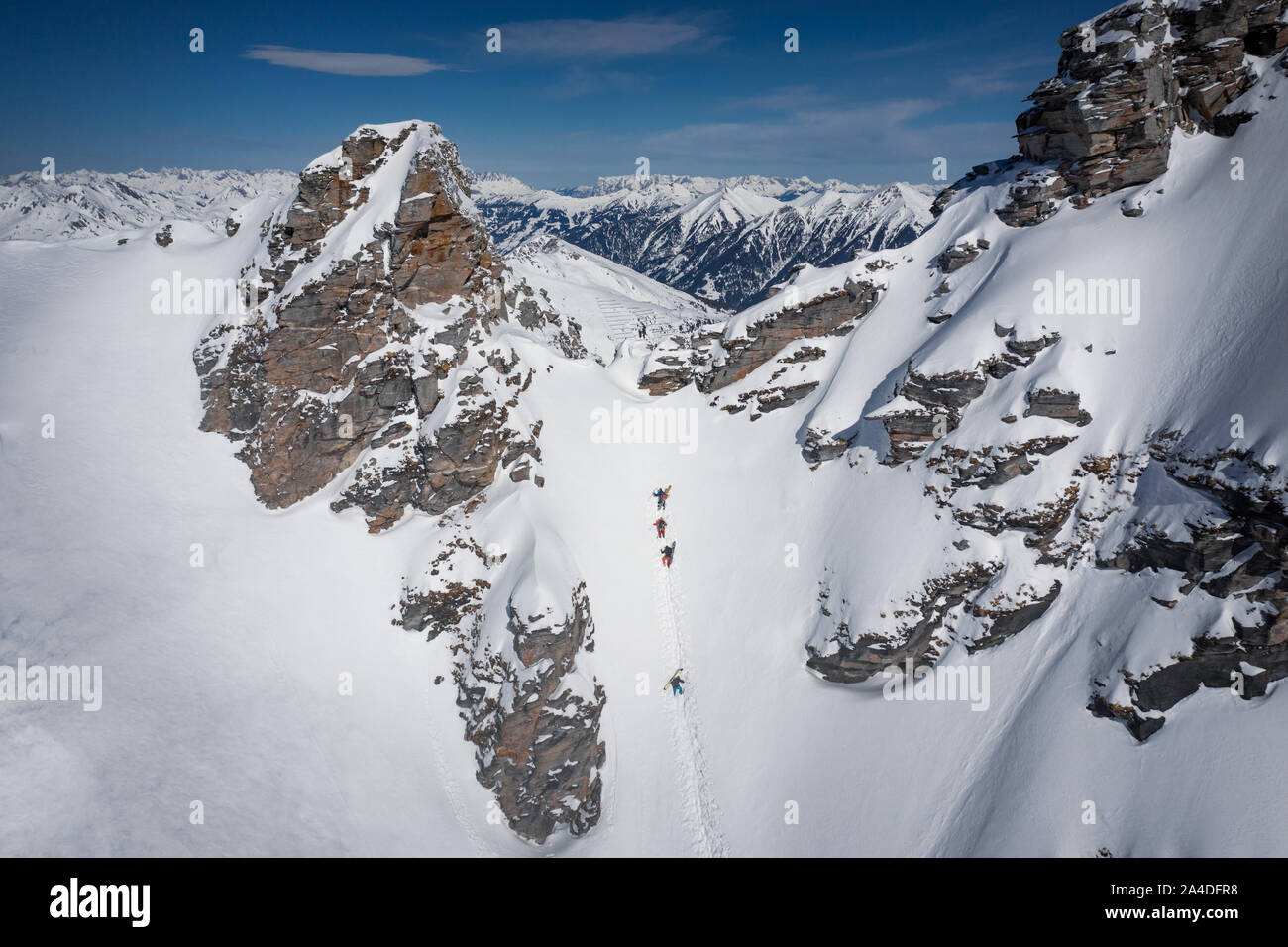 Vier Skifahrer Wandern auf einen steilen Hang im Backcountry des Skigebiet Gastein, Salzburg, Österreich Stockfoto