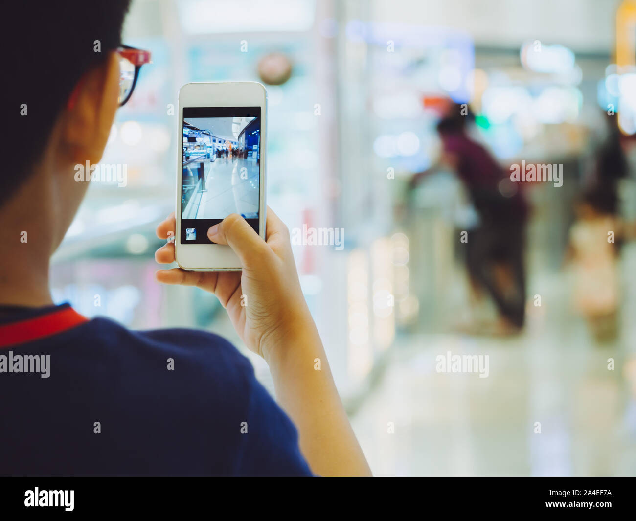 Hand kid Person mit Smartphone oder Handy ein Foto in einer Shopping Mall. Shopping Mall beliebteste Ort und gehen auf Weg mit Glück. Stockfoto