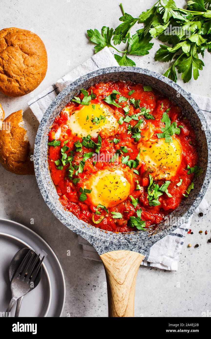 Traditionelle shakshuka in der Pfanne. Gebratene Eier in Tomatensoße mit Kräutern. Stockfoto