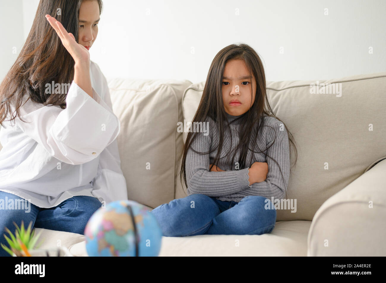 Wütend asiatischen Mutter sitzen mit kleinen Tochter, Mama schimpft für Disziplin schlechtes Verhalten kapriziöses Kind, Familie Generationen Probleme, misunderstandin Stockfoto