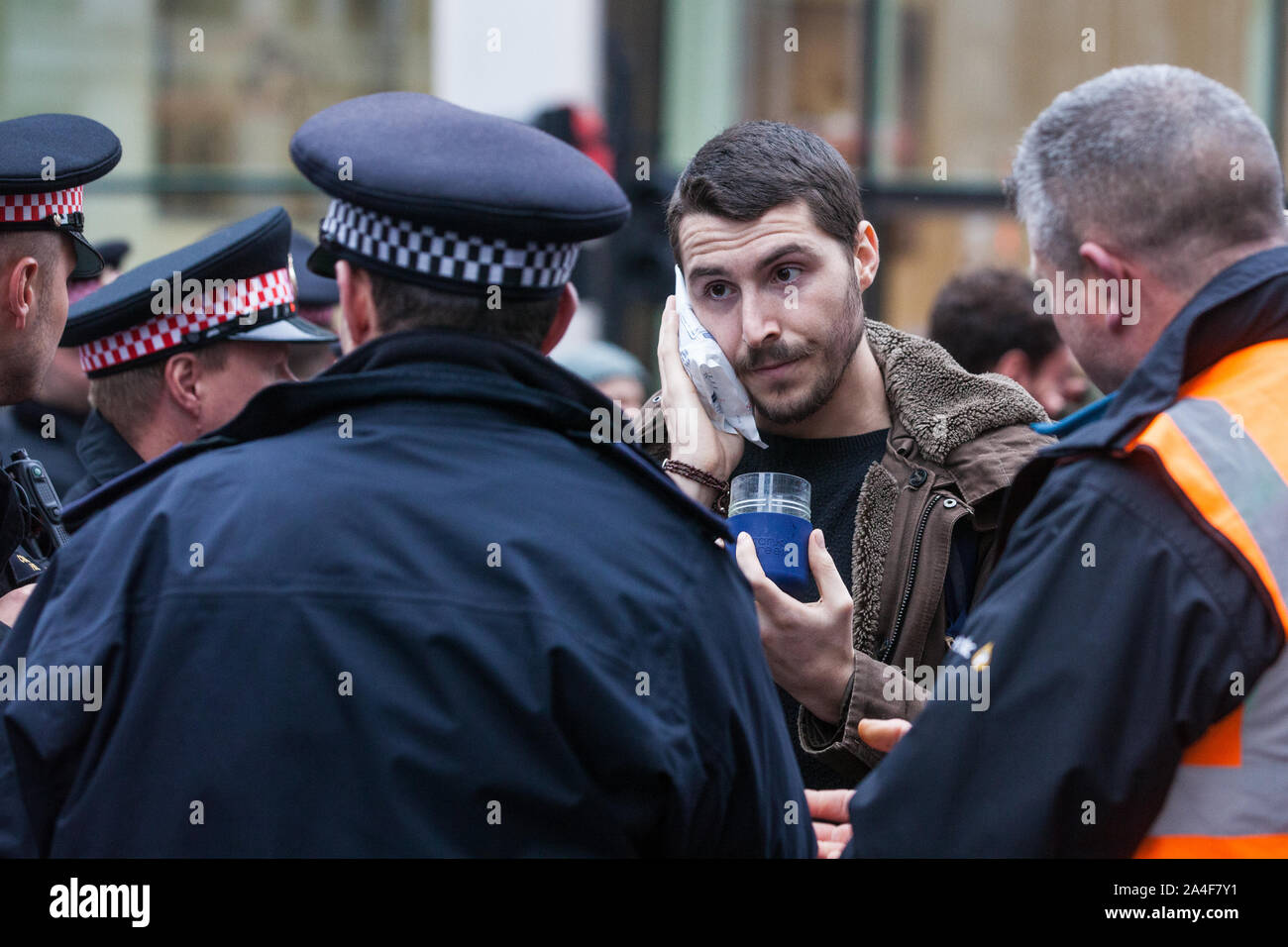 London, Großbritannien. 14. Oktober, 2019. Polizisten sprechen zu einem Klima Aktivist aus Aussterben Rebellion, die angegriffen wurde, von einem Mann in King William Street und am achten Tag des Internationalen Rebellion über London Proteste. Heute wurden die Aktivitäten rund um die Stadt von Londons Finanzviertel konzentriert. Credit: Mark Kerrison/Alamy leben Nachrichten Stockfoto