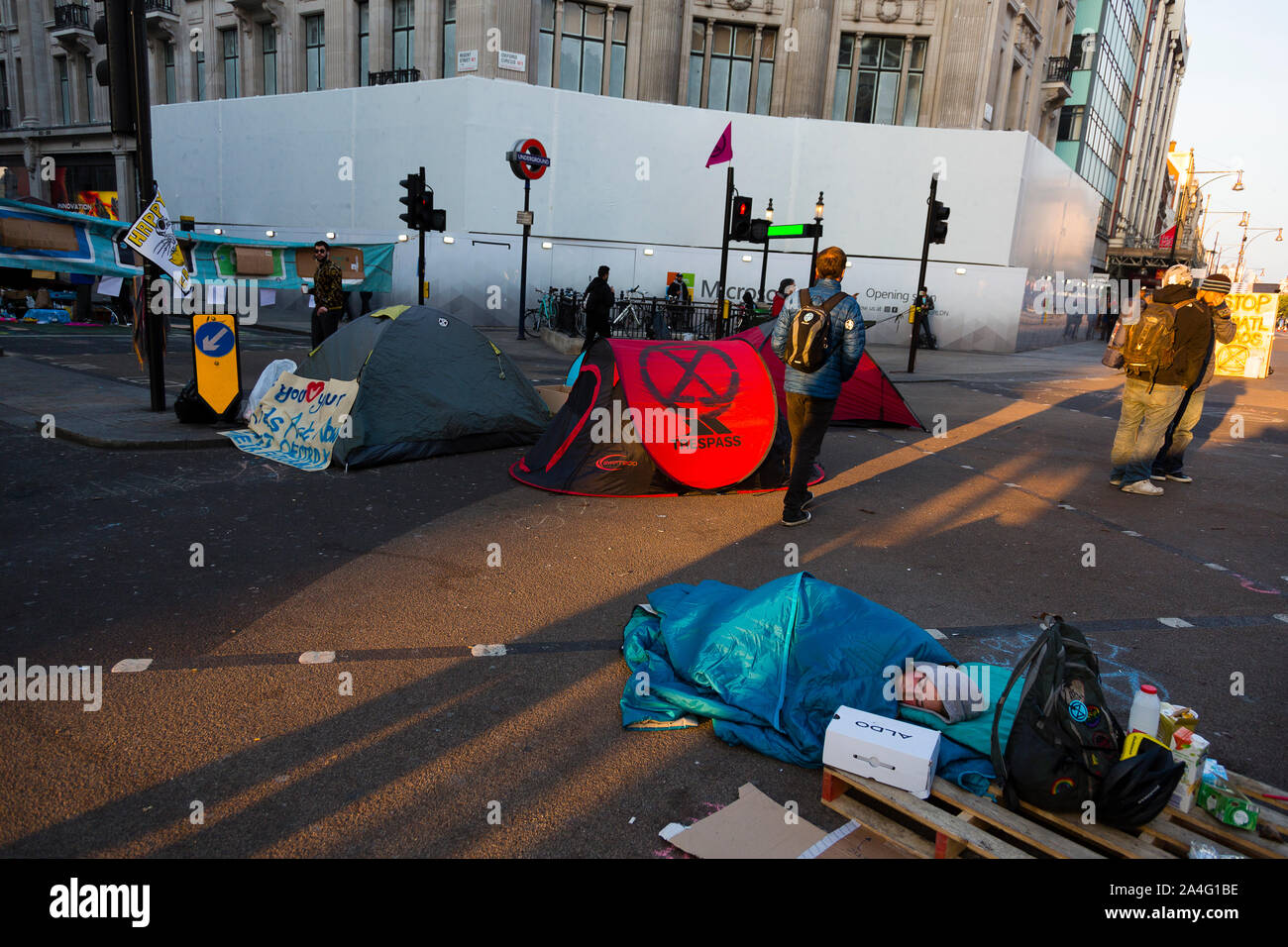 London, Großbritannien. Ein Aussterben Rebellion Demonstrant in einem blauen Schlafsack mitten in Oxford Circus. Stockfoto