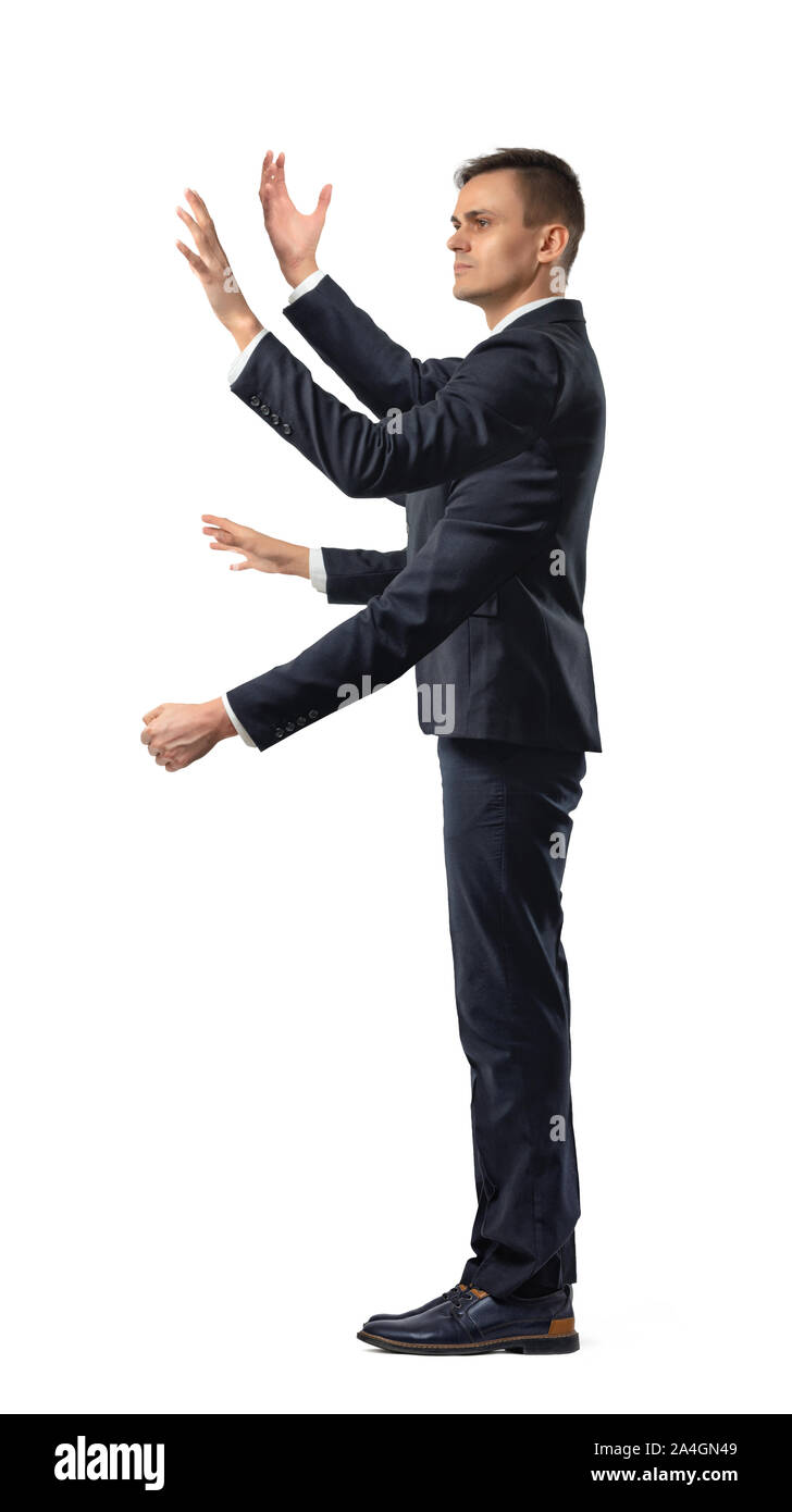 Ein Geschäftsmann mit vier Händen, grabbing Bewegungen und eine Faust in der Seitenansicht auf weißem Hintergrund. Stockfoto