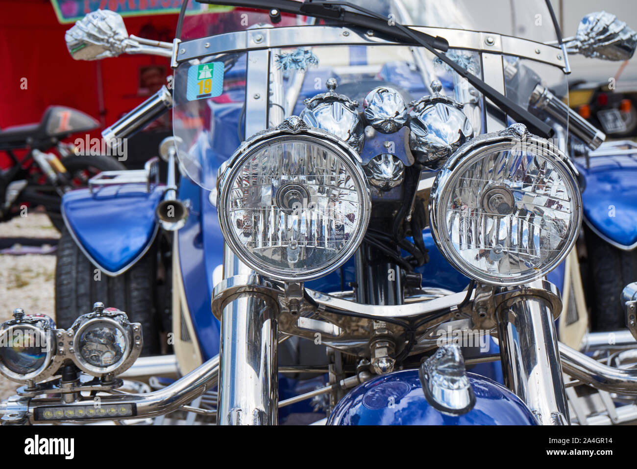 Pontarlier - Bourgogne Franche Comté Frankreich - 16. Juni 2019 - Die Sonne scheint über einen Kopf Licht auf ein Blau und Chrom Trike auf lokaler Auto Rallye. Stockfoto