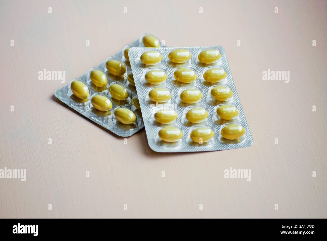 Geschlossene gelbe Tablette in Blisterpackung. Kapseln und Pillen in Blasen verpackt. Pharma- und Gesundheitskonzept. Stockfoto