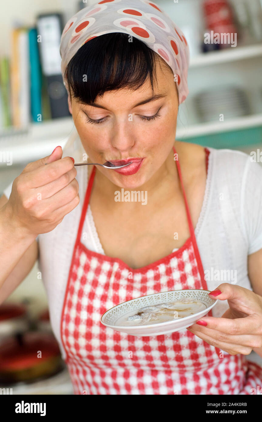 Hausfrau mit Schürze Verkostung kochen Stockfoto