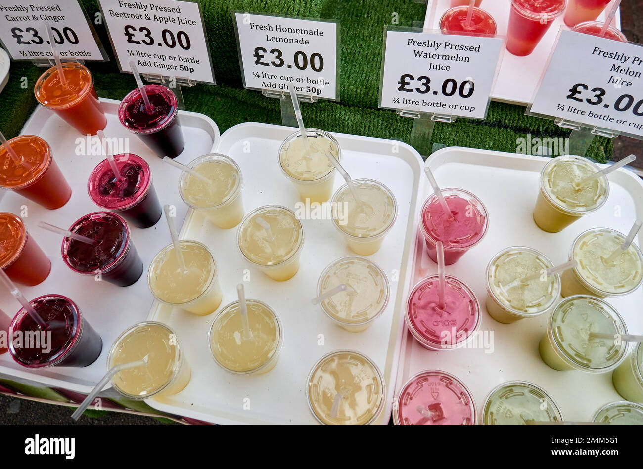Markt mit verschiedenen frisch gepresste Säfte in Plastikbechern. Mit Preisen. Ansicht von oben. Stockfoto