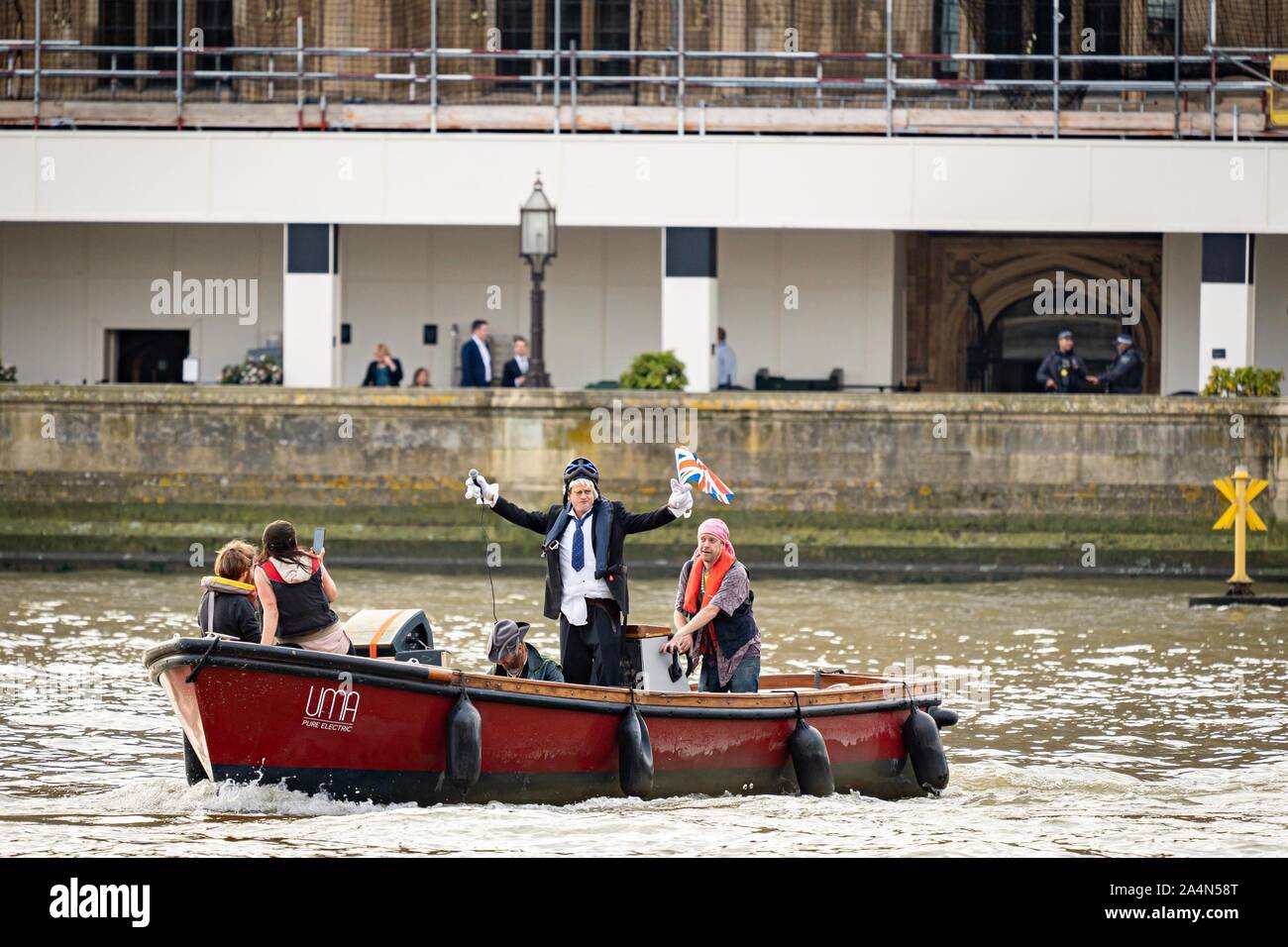 London, Großbritannien. 15 Okt, 2019. Aussterben Rebellion Demonstranten auf einem Boot in der Nähe der Westminster Bridge mit einem Boris Johnson Imitator in London, UK. Quelle: Wladimir Morosow/akxmedia. Quelle: Wladimir Morosow/Alamy leben Nachrichten Stockfoto