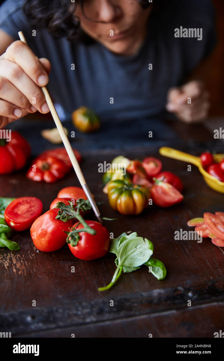 Frau Anordnen von Tomaten für Foto Stockfoto