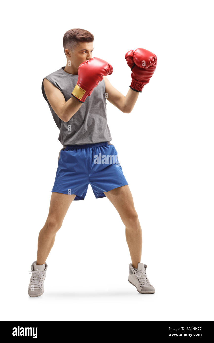 Volle Länge geschossen von einem jungen Kerl training Boxen mit roten Handschuhe auf weißem Hintergrund Stockfoto