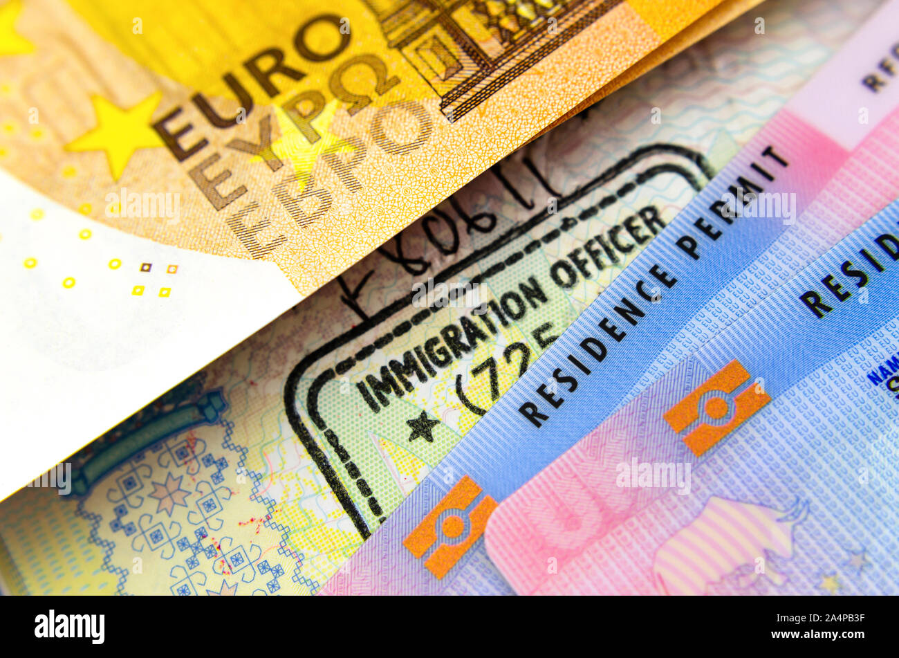 UK biometrischen Aufenthaltstitels Karten, Einreisestempel im Reisepass und ein Euro Banknote. Das Konzept Foto für Einwanderung. Stockfoto