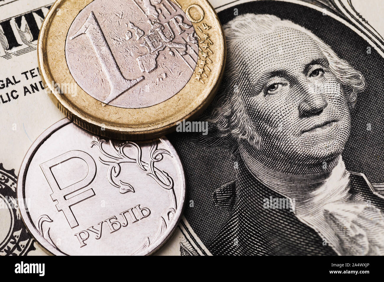Euro Münze und Russische Rubel vor dem Hintergrund von einem Dollar Bill, close-up. Die Münze hat eine Inschrift in russischen Buchstaben Rubel Stockfoto