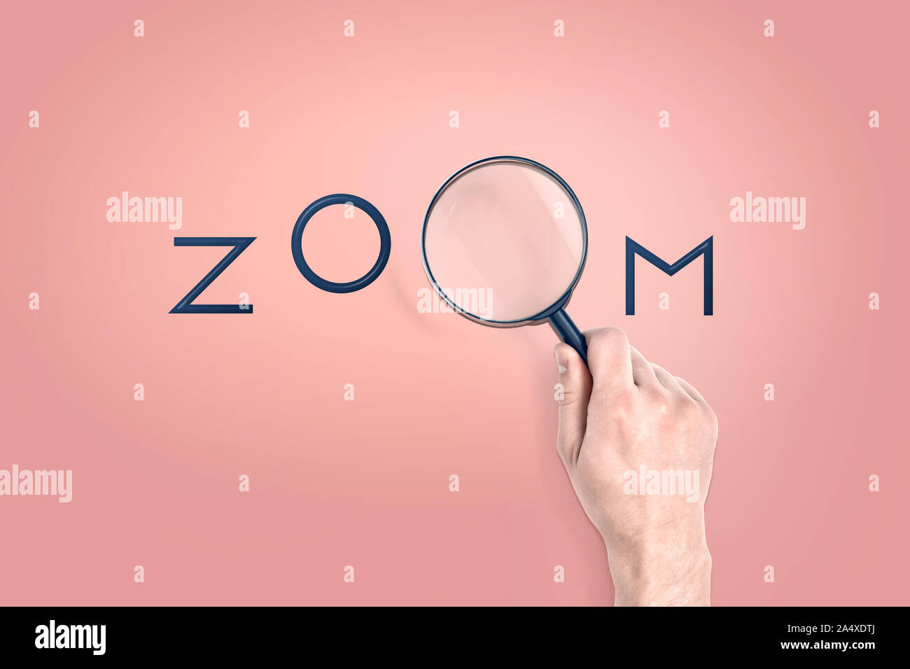 Männliche Hand hält eine große Lupe, die als Buchstaben in einem Wort Zoom dient. Stockfoto