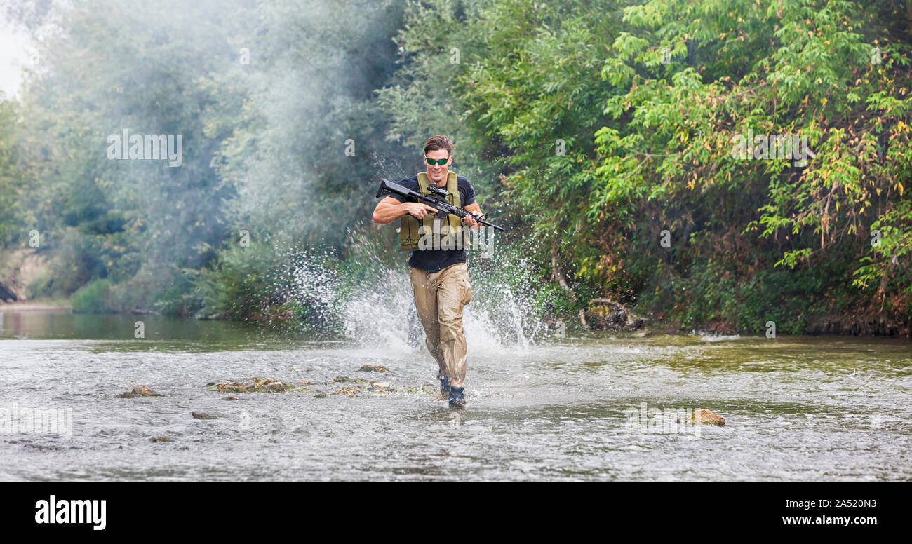 Volle militärische Erfahrung - Ein Tag Commando - der durch das Wasser mit einer Kalaschnikow Sturmgewehr AK-47 Replik Stockfoto