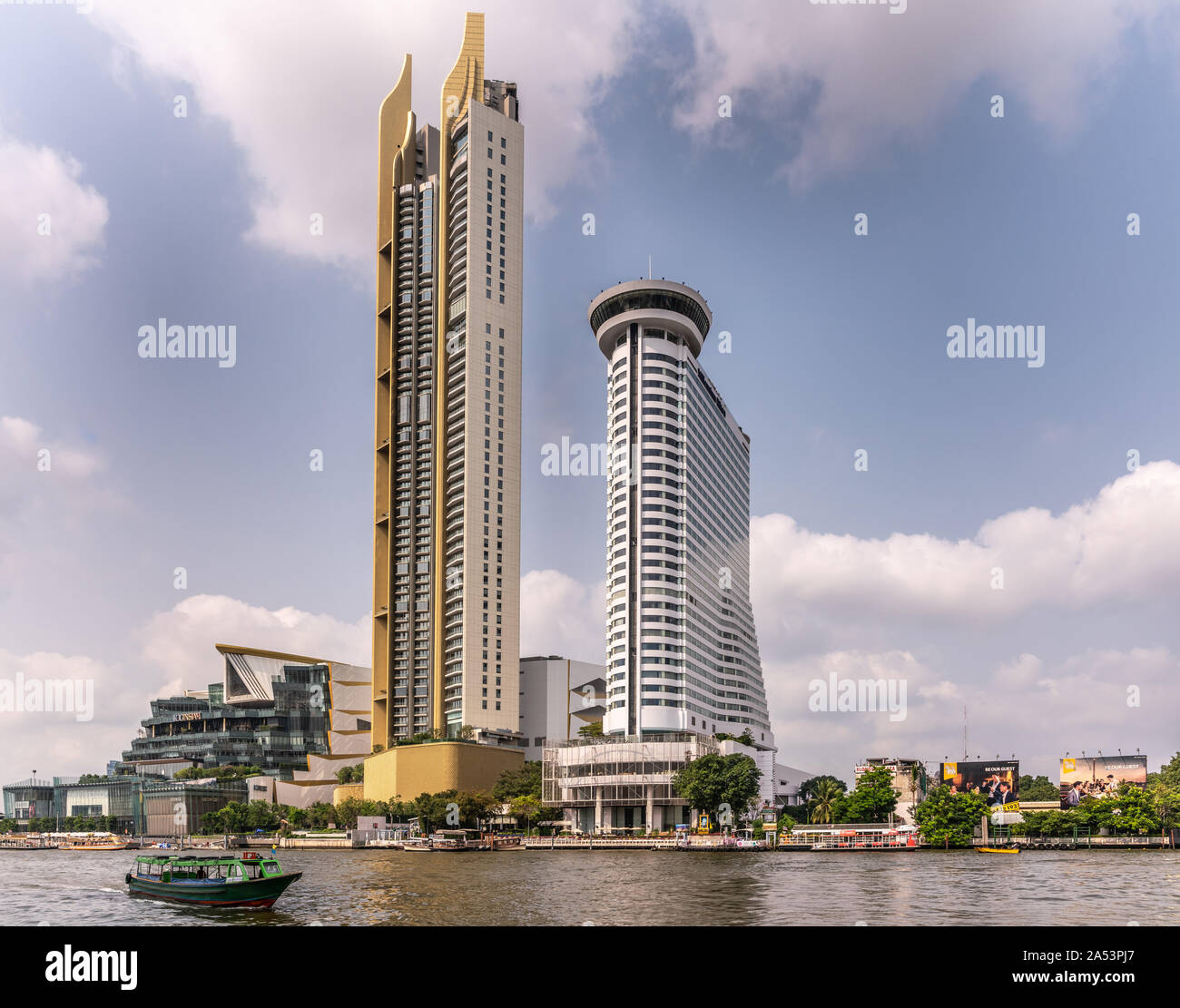 Die Stadt Bangkok, Thailand - 17. März 2019: Millennium Hilton weiße Gebäude und dem angrenzenden Gelbe Turm entlang den Fluss Chao Phraya mit Boot gegen den blauen Himmel Stockfoto