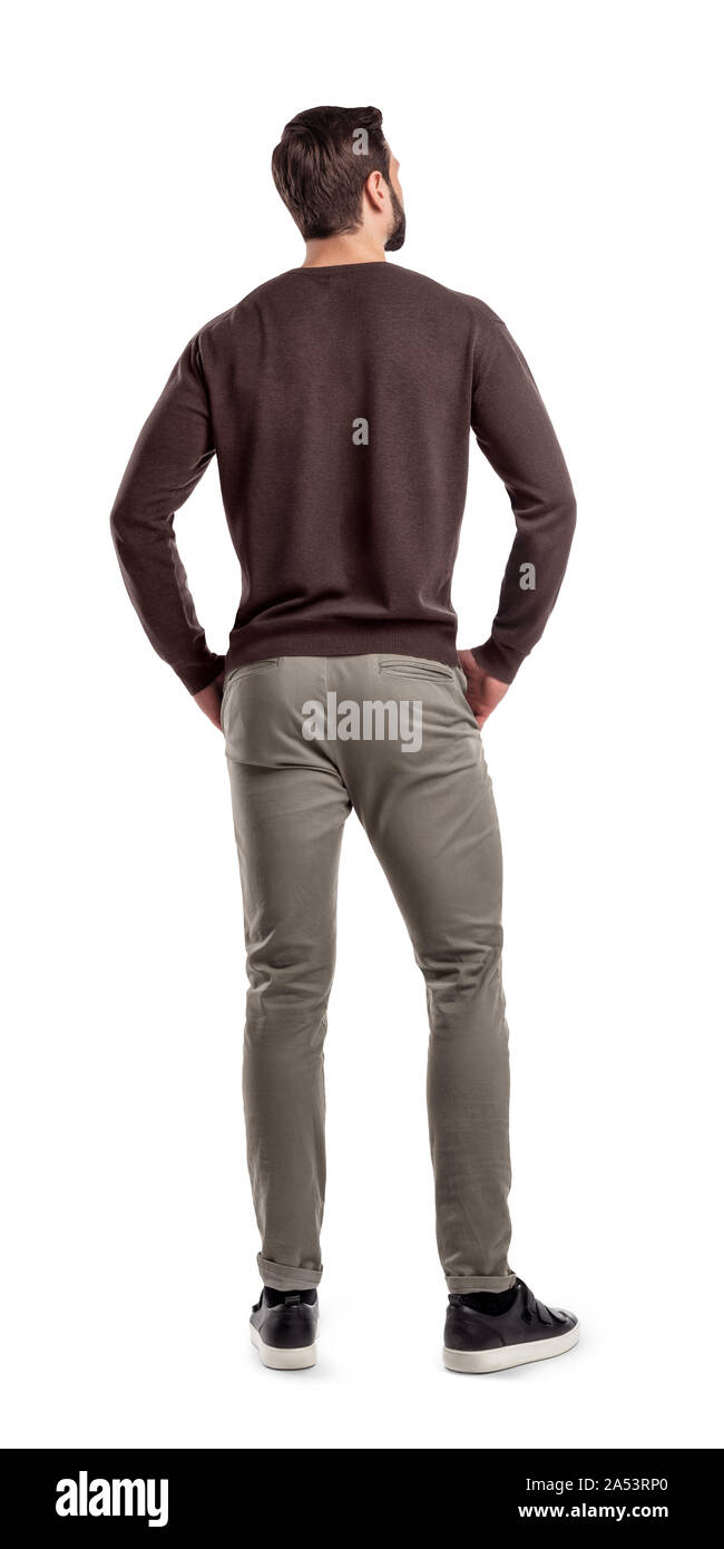 Eine Rückansicht auf einem modernen locker und leger gekleidete Mann, steht in einer entspannten Körperhaltung und sieht seitwärts. Stockfoto