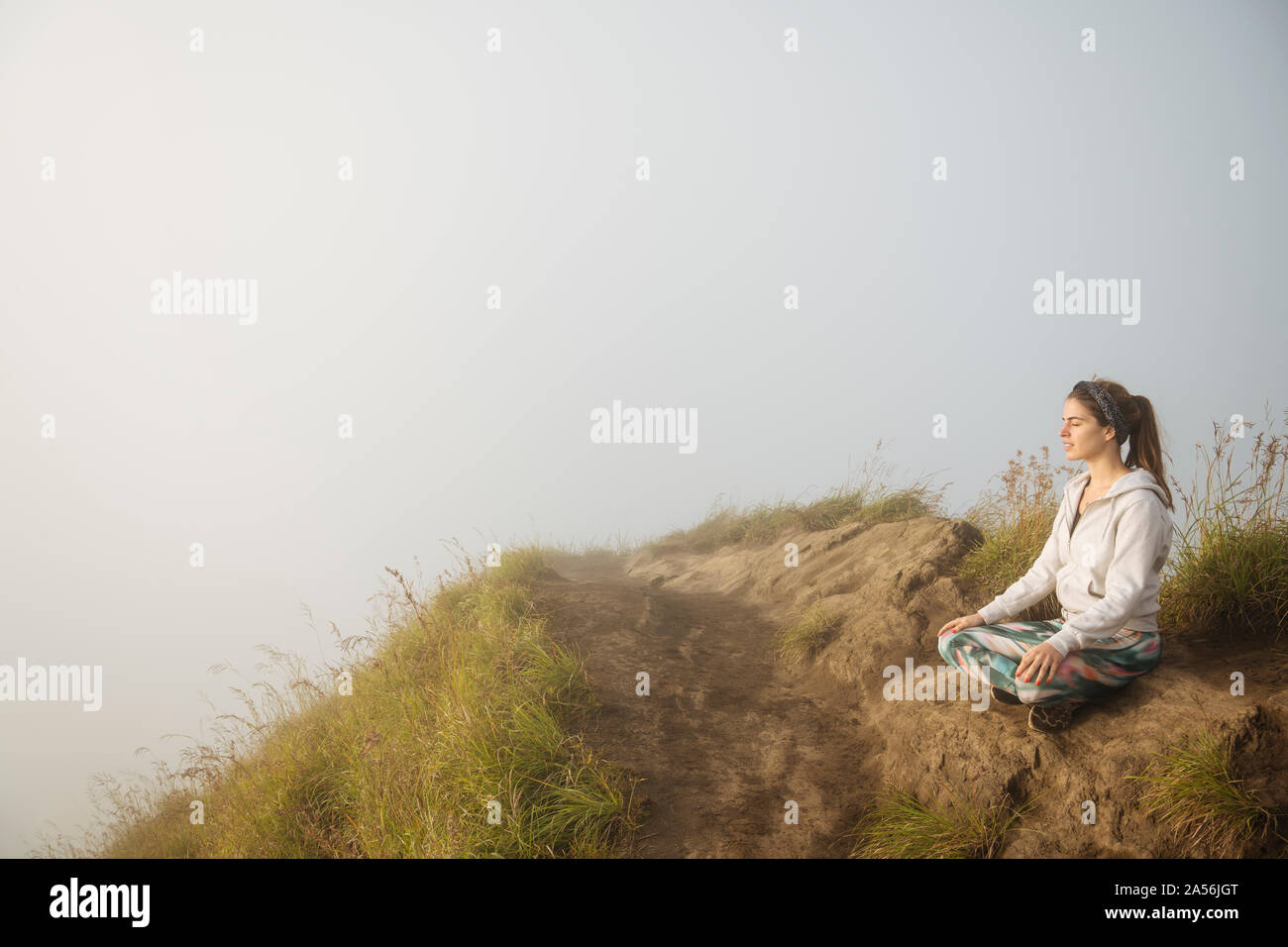 Junge Frau mit Yoga auf Misty Mountain, Bali, Indonesien Stockfoto