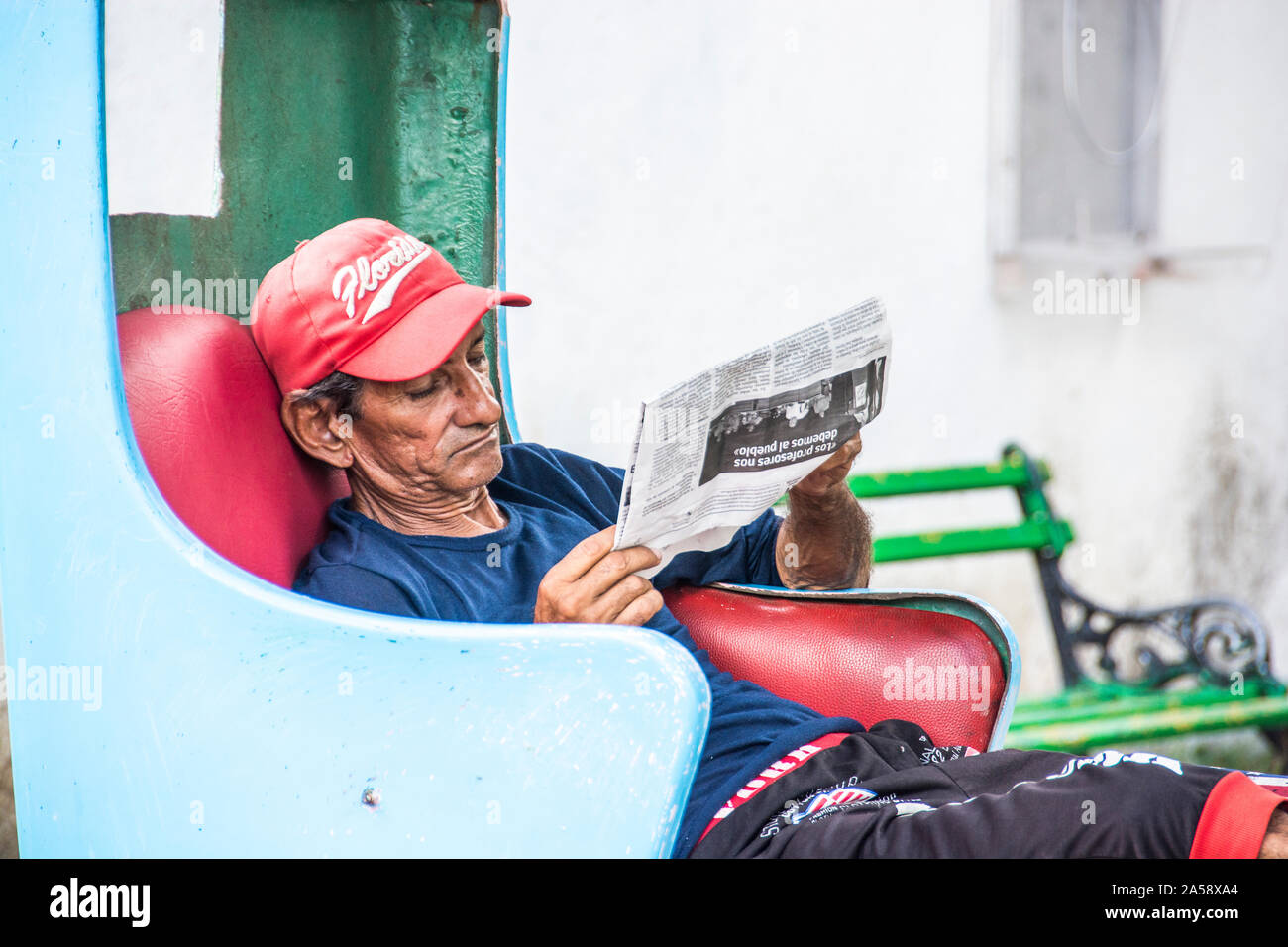 Ein Mann, der in seinem Taxi sitzt und darauf wartet, dass jemand kommt, um eine Fahrt zu machen; Camaguey, Kuba Stockfoto