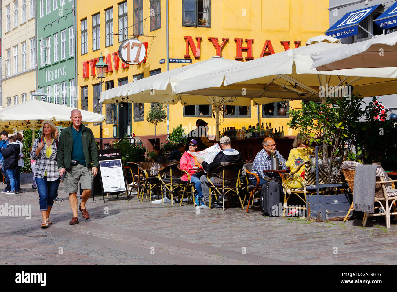 Kopenhagen, Dänemark - 4 September, 2019: ein Paar sind zu Fuß in den Stadtteil Nyhavn neben den Restaurants mit Sitzgelegenheiten im Freien. Stockfoto