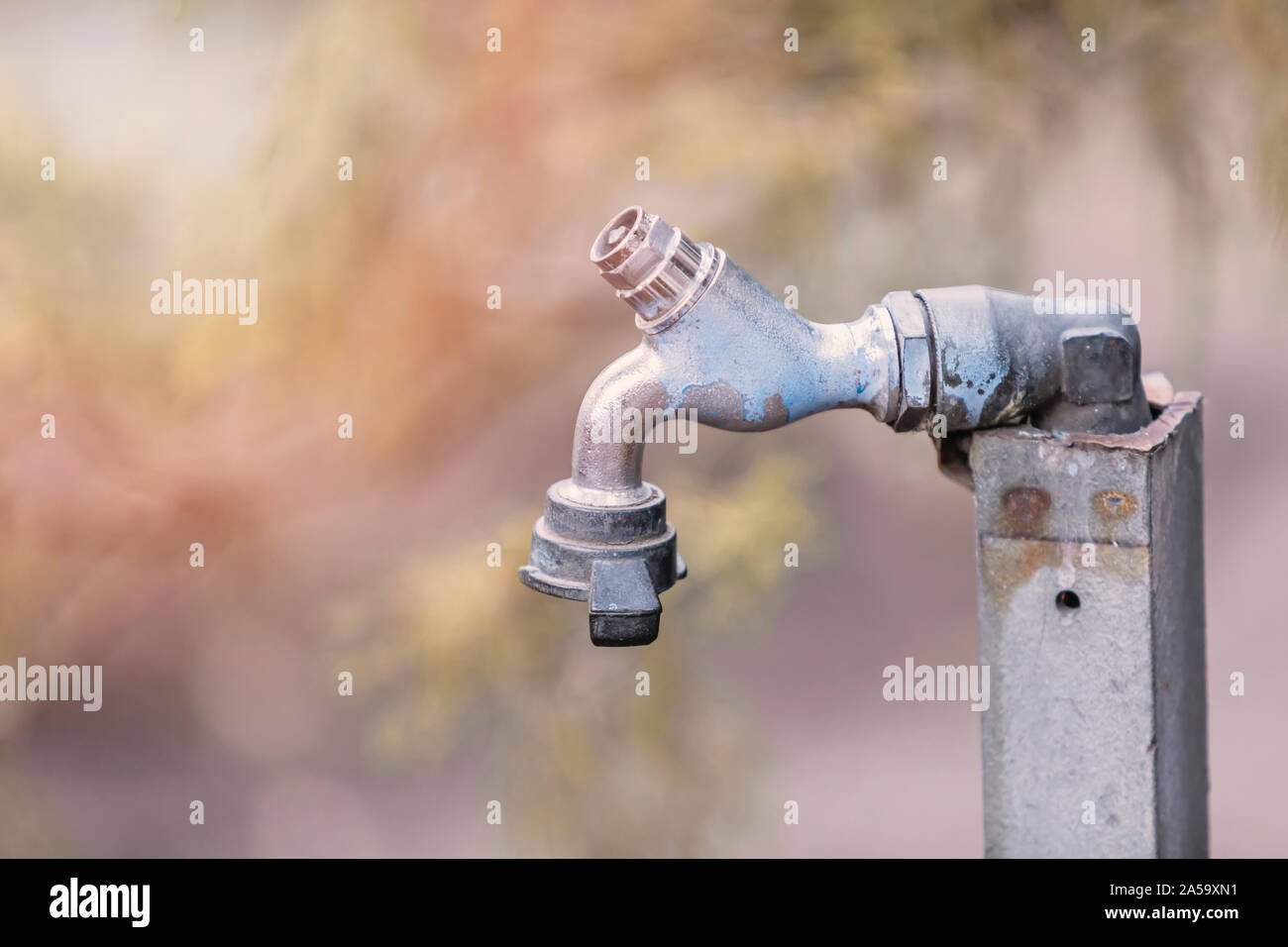 Eine alte Metall Wasserhahn draußen in der Natur, mit Kopie auf der linken Seite. Stockfoto