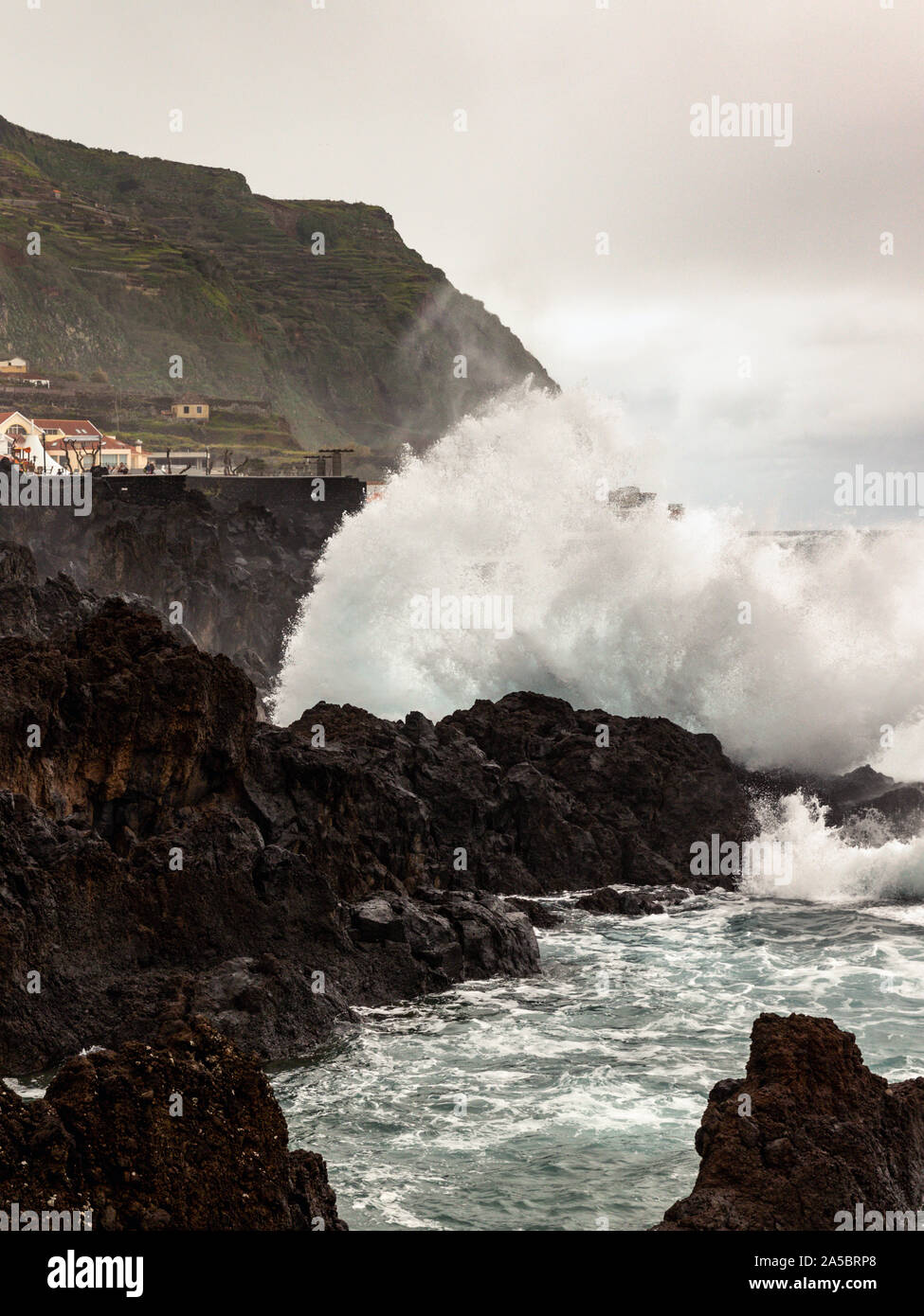 Wellen auf die Felsen am open air Atlantischen Ozean Meer Wasser natürliche Schwimmbäder in Porto Moniz, Madeira, Portugal Stockfoto
