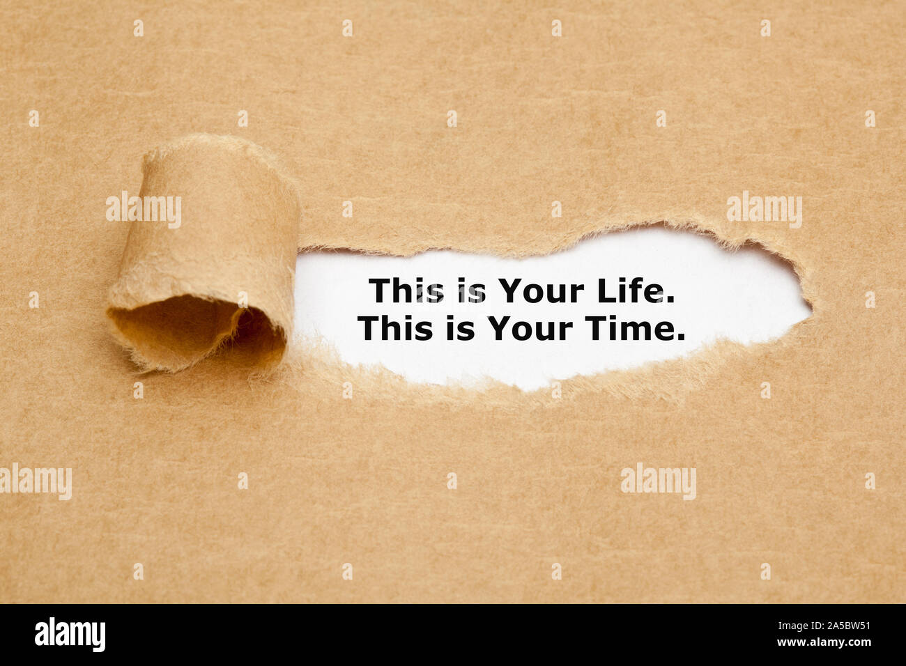 Motivierende zitat Dies ist Ihr Leben Das ist Ihre Zeit hinter zerrissen braunes Papier erscheint. Stockfoto
