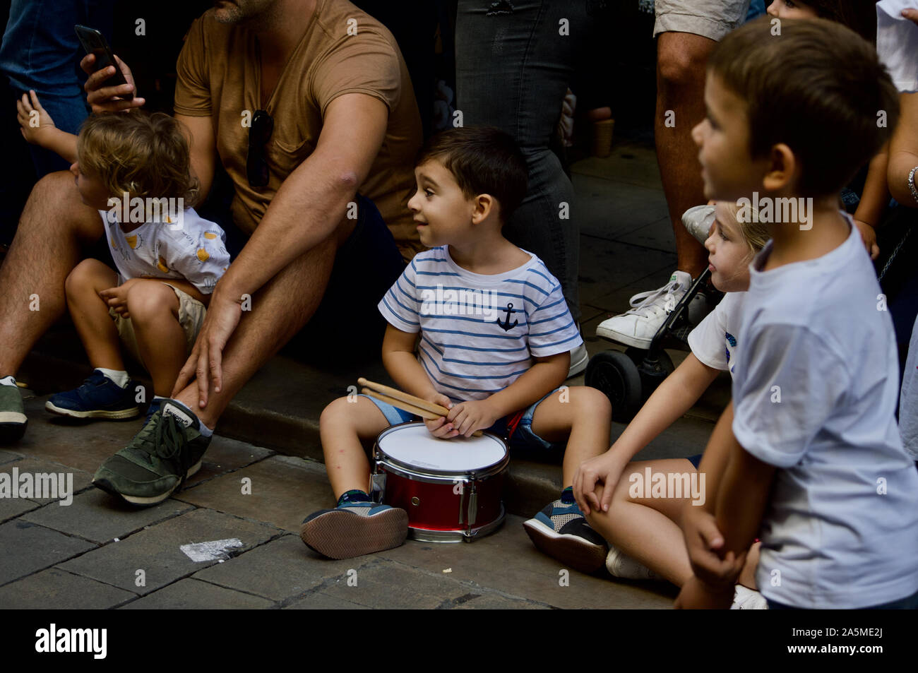 Ein Junge spielt eine Trommel an der Riesen Parade während La Merce Festival 2019 am Placa de Sant Jaume in Barcelona, Spanien Stockfoto
