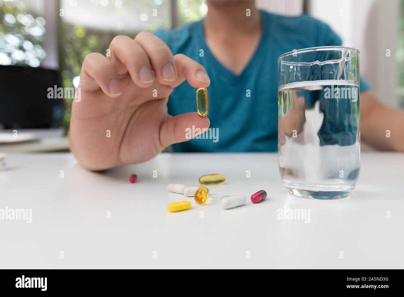 Junger Mann mit der pharmazeutischen Medizin Pillen in der Hand Stockfoto