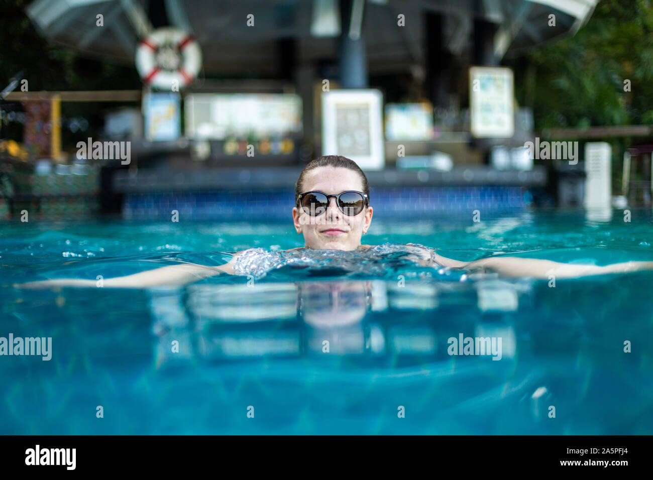Junge Frau Entspannung im Schwimmbad Stockfoto