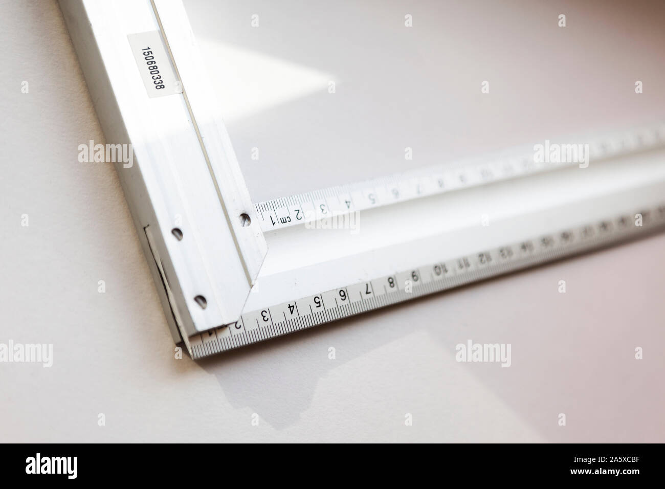 Ein Quadrat auf hellen Hintergrund mit Zentimeterskala, dreieckige Werkzeug Dreiecke zu markieren und zu messen. Stockfoto